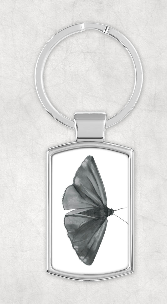 A Cinnabar Moth Metal Rectangular Keyring featuring a detailed hand-drawn illustration of the striking red and black moth, perfect for insect and nature lovers.