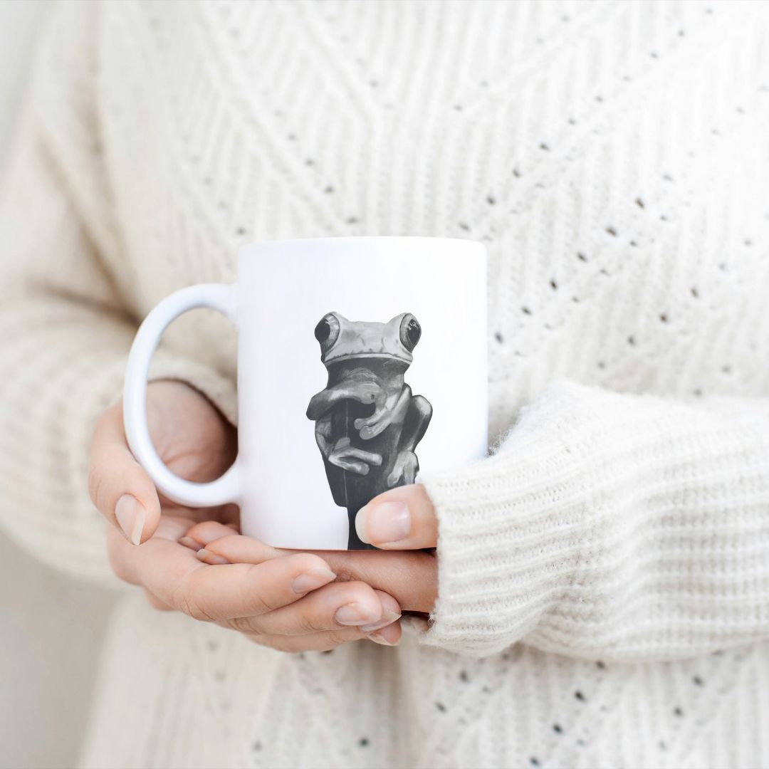 Frog  11 oz Ceramic Mug From Libra Fine Arts. . Hand-drawn countryside cute otter design ceramic mug, the perfect gift for family members, featuring intricate artwork and a personal touch. Great birthday present and christmas presents for those who love frogs and other wildlife