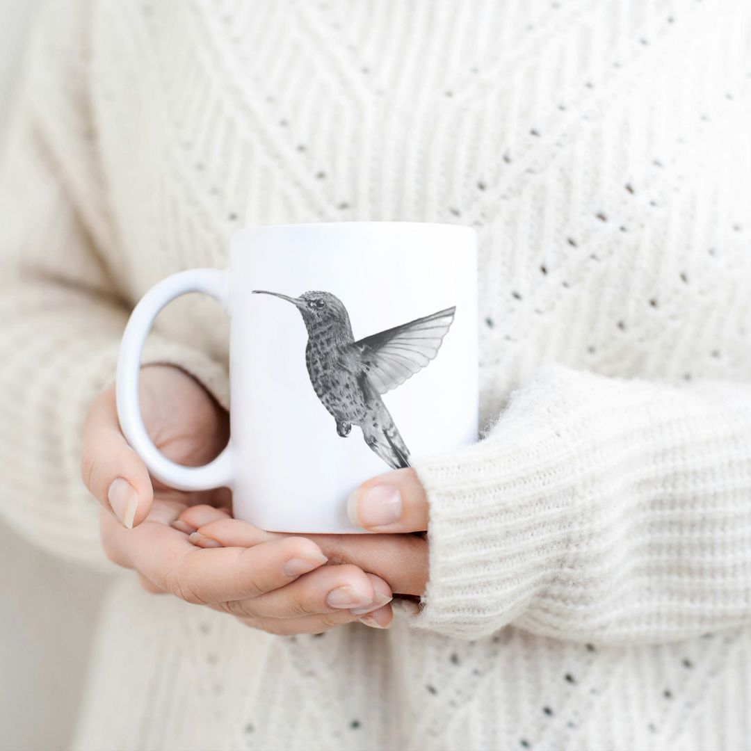 Hand-drawn hummingbird design ceramic mug, the perfect gift for family members, featuring intricate artwork and a personal touch.