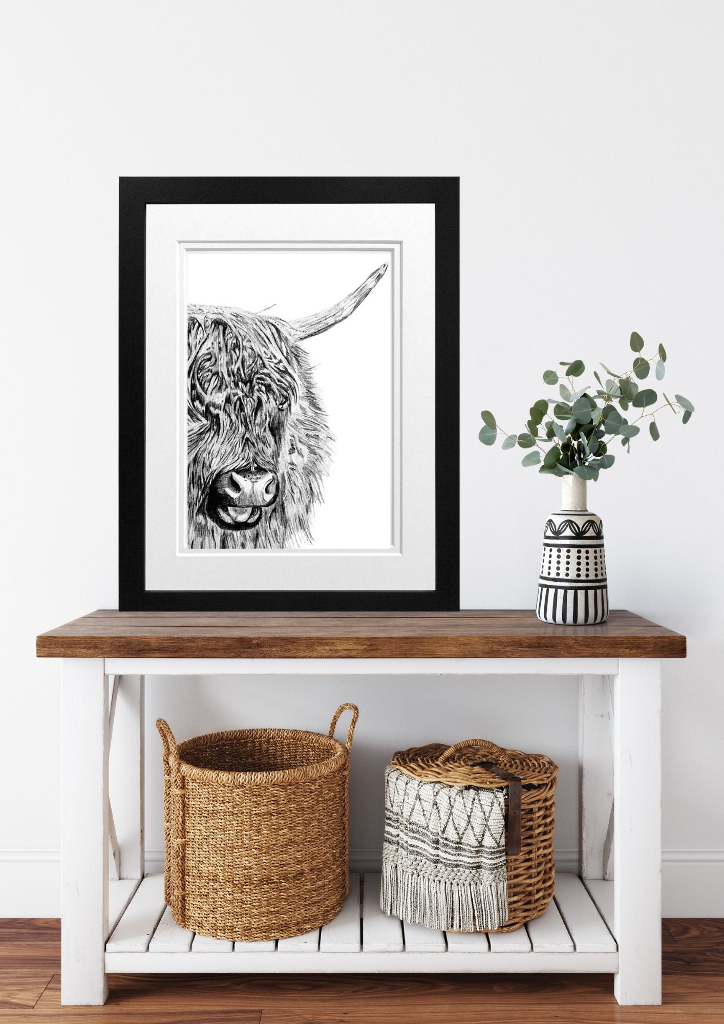 Libra_Fine_Arts_Hand_Drawn_Highland_Cow_Drawing_in_Black_Frame_on_a_side_table_ib_the_hallway__perfect_gift_for_countryside_and_highland_cow_lovers.