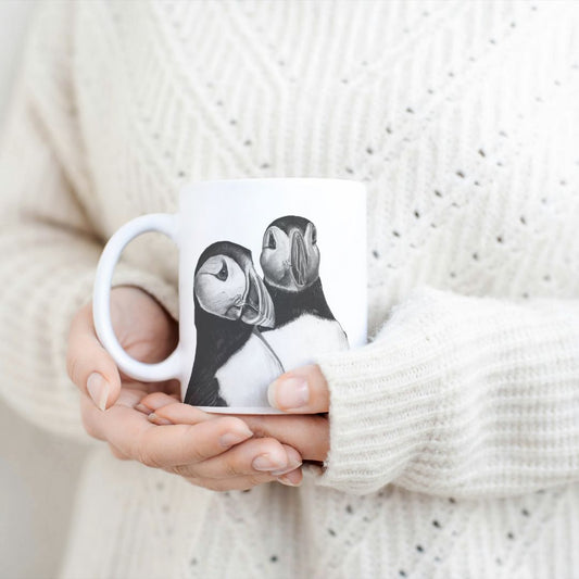 Puffins 11 oz Ceramic Mug From Libra Fine Arts.  . Hand-drawn puffin design ceramic mug, the perfect gift for family members, featuring intricate artwork and a personal touch. Great birthday present and christmas presents for those who love puffins and the british countryside