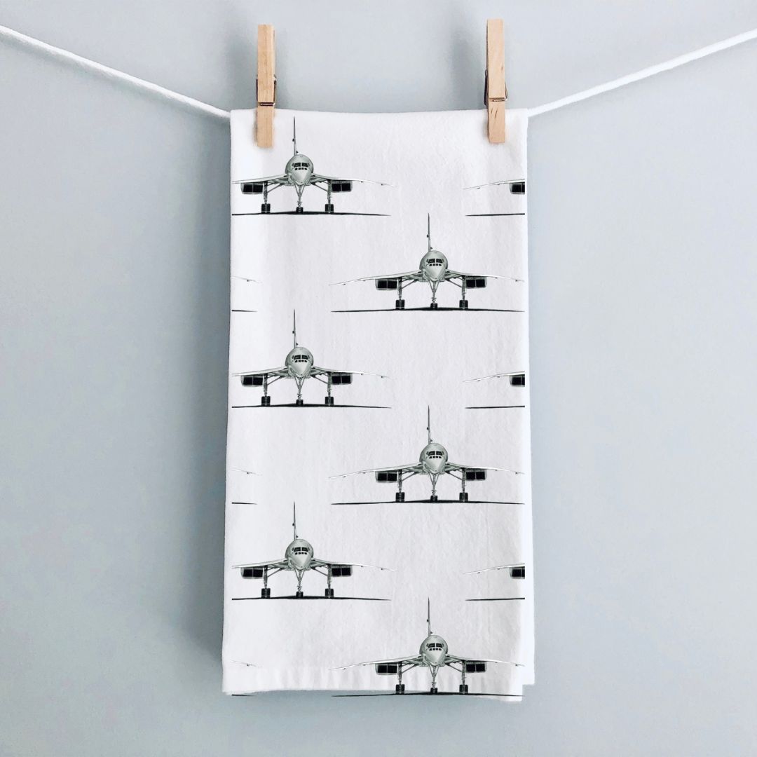 A hand-drawn Concorde-patterned tea towel, made from premium cotton, hanging over an oven door. This aviation-inspired design brings a touch of elegance and nostalgia to your kitchen, perfect for aviation enthusiasts and those who appreciate classic aircraft. A stylish and practical addition to your home, ideal for gifting to Concorde fans or anyone who loves unique, travel-themed decor.







