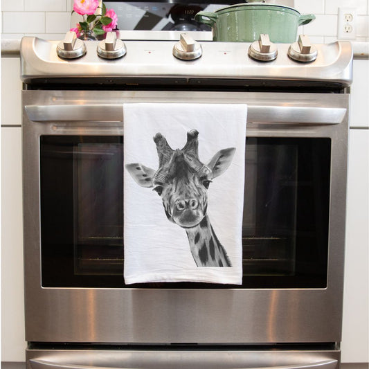 Giraffe Premium Tea Towel From Libra Fine Arts . Giraffe Tea Towel: A stylish tea towel featuring a hand-drawn giraffe design. Made from high-quality fabric, this charming towel is perfect for birthday gifts or Christmas presents, adding a touch of whimsy and elegance to any kitchen. Ideal for giraffe enthusiasts and those who appreciate unique, nature-inspired designs